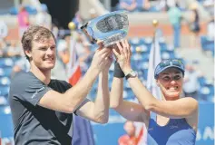  ??  ?? Hingis and Murray hold trophy after defeating Hao-Ching Chan of Taiwan and Michael Venus of New Zealand. — Reuters photo