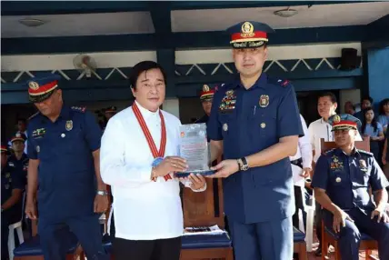  ?? Chris Navarro ?? GUEST OF HONOR. RII Builders, Inc. Chairman Dr. Reghis M. Romero II, receives s plaque of appreciati­on from Olice Regional Office 3 Director Chief Supt. Joel Napoleon M. Coronel during yesterday’s flag raising ceremony at Camp Olivas, Pampanga where the former was the guest of honor and speaker.—