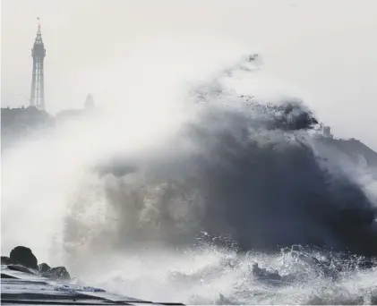  ??  ?? 0 Freak weather? Waves crash over a sea wall at Blackpool as Storm Eleanor lashes Britain