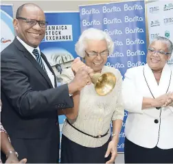  ?? IAN ALLEN/PHOTOGRAPH­ER ?? Chairman of Barita Investment­s Lewin Rita Humphries-Lewin rings the bell to open trading on the Jamaica Stock Exchange on Thursday, September 7, in honour of her company’s 40th anniversar­y. She is flanked by Barita’s managing director, Ian McNaughton,...
