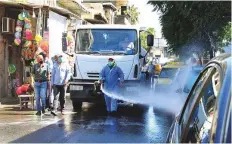  ?? AP ?? A worker disinfects a street in Damascus. Nine years of war have battered health care infrastruc­ture across Syria.
