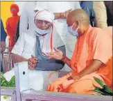  ?? HT PHOTO ?? Chief minister Yogi Adityanath in conversati­on with late Kalyan Singh’s son Rajveer Singh, the BJP MP from Etah, at the 13th day ritual.