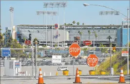  ?? Mark J. Terrill The Associated Press ?? Games will played in big-league stadiums with no fans when baseball returns, including Dodger Stadium, and the season will be a 60-game sprint.