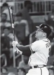  ?? THE ASSOCIATED PRESS ?? The Atlanta Braves’ Freddie Freeman watches the flight of a ball hit for a solo home run in the sixth inning against the Arizona Diamondbac­ks on Friday in Atlanta. He added an RBI single in the Braves’ two-run eighth.