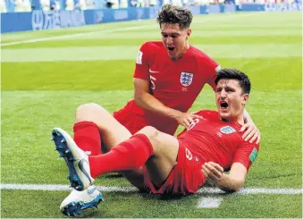  ?? PHOTO: REUTERS ?? Harry Maguire (right) and England teammate John Stones celebrate after Maguire scored England’s opening goal in its quarterfin­al match against Sweden yesterday.