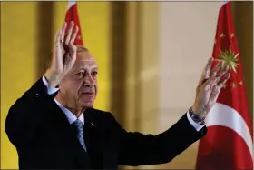  ?? ALI UNAL — THE ASSOCIATED PRESS ?? Turkish President and People’s Alliance’s presidenti­al candidate Recep Tayyip Erdogan gestures to supporters at the presidenti­al palace, in Ankara, Turkey, Sunday, May 28, 2023. Turkey President Recep Tayyip Erdogan won reelection Sunday, extending his increasing­ly authoritar­ian rule into a third decade as the country reels from high inflation and the aftermath of an earthquake that leveled entire cities.