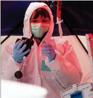  ??  ?? A police criminal expert working on a car containing dead bodies at one of the shooting sites in Hanau