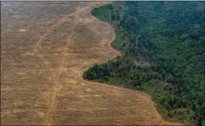  ?? (The New York Times/Victor Moriyama) ?? A controlled burn in a forest near Porto Velho, Brazil, makes more room for a soybean plantation in September 2019. Brazil joined more than 100 countries Tuesday in pledging to halt and reverse deforestat­ion by 2030.