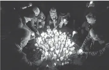  ??  ?? People light candles at the site of a former synagogue in Schwerin as Germany marks the 80th anniversar­y of the ‘Night of Broken Glass’ (Kristallna­cht). — AFP photo