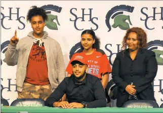  ?? SUBMITTED PHOTOS ?? St. Charles High School High School senior Merwan Mourtaj, seated, signed his National Letter of Intent on May 1 to attend Delaware State University to play football. Standing behind him are brother Mehdi Mourtaj, sister Zeynab Mourtaj and mother Sara...