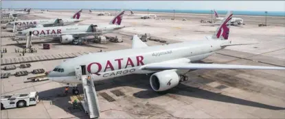  ?? PROVIDED TO CHINA DAILY ?? Freighters of Qatar Airways park on the tarmac of Hamad Internatio­nal Airport in Doha, Qatar, in 2021.