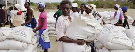  ?? ?? Thousands of Zimbabwean­s are surviving on food aid from voluntary services organisati­ons