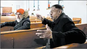  ?? KYLE TELECHAN/POST-TRIBUNE ?? The Rev. Hugh Nelson, right, speaks about the struggles that his Abyssinian Baptist Church has had with the county denying it tax-exempt status as church director Otto Schulze listens on Tuesday.