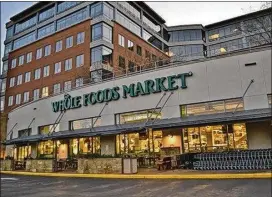  ?? AMERICAN-STATESMAN ?? Whole Foods’ flagship store is at 525 N. Lamar Blvd. in downtown Austin. If Amazon’s $13.7 billion purchase is approved, the combined company would reportedly have less than 2 percent of the grocery market, according to industry analysts.