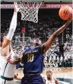  ??  ?? Notre Dame’s TJ Gibbs puts up a shot against Michigan State’s Miles Bridges on Thursday.
| AP