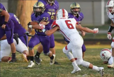  ?? ERIC BONZAR — THE MORNING JOURNAL ?? Vermilion running back Caine Zannoni (33) eyes Firelands defensive back Nick Denney (6) last season. The teams face off on Sept. 8 this year.