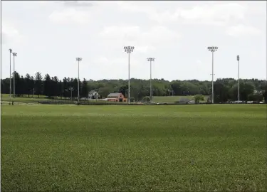  ?? CHARLIE NEIBERGALL ?? Light stands from a baseball field being built near the Field of Dreams movie site, rear, are seen, Friday, June 5, 2020, in Dyersville, Iowa.