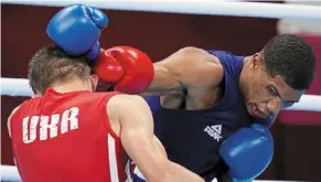  ?? — ap ?? In the face: Brazil’s Hebert Sousa (right) landing a punch on ukraine’s Oleksandr Khyzhniak during their men’s middleweig­ht bout.