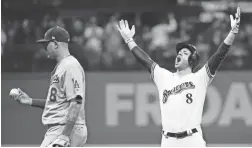  ??  ?? The Brewers’ Ryan Braun reacts after hitting an RBI double in Game 6 of the National League Championsh­ip Series baseball game against the Dodgers on Friday in Milwaukee.