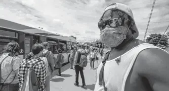  ?? ERIC WYNNE/CHRONICLE HERALD ?? A man wearing a mask waits for the bus at the Mumford Terminal Friday afternoon. Starting July 25, it will be mandatory for drivers and passengers to wear a non-medical mask on public transit, including taxis.