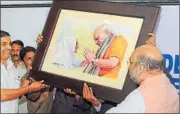  ??  ?? BJP national president Amit Shah receives a painting of Prime Minister Narendra Modi at the NDA Kerala unit meeting in Kozhikode, Kerala, on Monday. PTI PHOTO