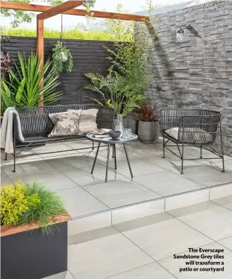  ?? ?? The Everscape Sandstone Grey tiles will transform a patio or courtyard