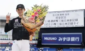  ?? Photograph: Kyodo News/Getty Images ?? Rōki Sasaki of the Chiba Lotte Marines poses after throwing a perfect game against the Orix Buffaloes on Sunday at Zozo Marine Stadium in Chiba, Japan.