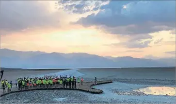  ?? Robin Abcarian Los Angeles Times ?? AT 8 P.M. Monday, the first wave of Badwater runners gathered before taking off 135 miles across a desert, three mountain ranges and 14,600 feet of ascent. Some 42 hours later, they will have finished or dropped out.