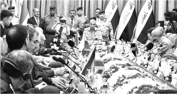  ??  ?? A handout picture shows Iraqi military commanders (centre) seated during a security cooperatio­n and informatio­n-sharing meeting with their Iranian (left bottom), Syrian, and Russian counterpar­ts in the Iraqi capital Baghdad. — AFP photo