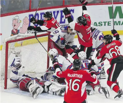  ?? TONY CALDWELL ?? A group of jubilant Senators celebrate Derick Brassard’s goal that evened the score at 4-4 with 1:26 left in the third period on Saturday. The Sens went on to win in overtime and now face the tough task of ending the series in Madison Square Garden,...