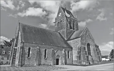  ?? CAMERON HEWITT/RICK STEVES’ EUROPE ?? During the D-Day invasion, off-course American paratroope­rs landed in the village of Ste-Mere Eglise. One paratroope­r’s chute caught on a church spire, which the village commemorat­es today with a mannequin dangling on the church.