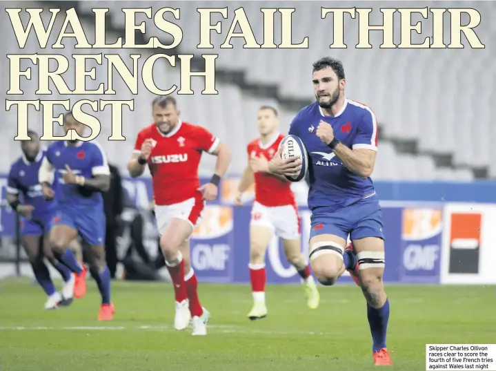  ??  ?? Skipper Charles Ollivon races clear to score the fourth of five French tries against Wales last night