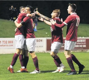  ?? ?? Delight Gary Thom is mobbed by team-mates after his goal