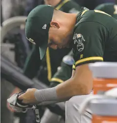  ??  ?? The Athletics’ Chad Pinder sits on the bench after the loss. The A’s have lost eight straight winner-take-all postseason games since beating Willie Mays and the New York Mets in Game 7 of the 1973 World Series.