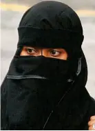  ??  ?? Covered: Face veils are banned