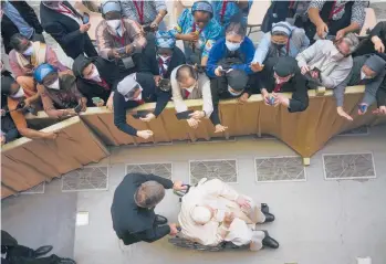  ?? ALESSANDRA TARANTINO/AP ?? Pope Francis, using a wheelchair for the first time, arrives for an audience with nuns and religious superiors from around the world Thursday at the Vatican. Francis, 85, has been suffering from strained ligaments in his right knee for months. Though he’s
recently received injections to relieve the pain, Francis continues to have issues with mobility.