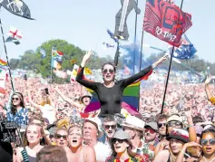  ??  ?? Revelers attend Glastonbur­y festival in 2019.