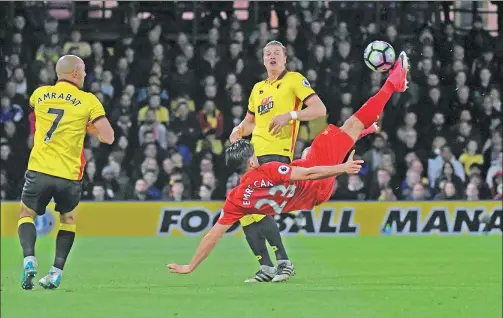  ?? TOBY MELVILLE / REUTERS ?? Liverpool’s Emre Can executes a mid-air scissors kick to score the winning goal against Watford in their England Premier League match at Vicarage Road on Monday.
