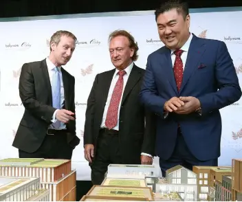  ??  ?? Ballymore Group chairman and CEO Sean Mulryan, centre, Ballymore’s UK managing director John Mulryan, left, and Oxley Holdings chairman Ching Chiat Kwong inspect a model of Dublin Landings, at the developmen­t’s launch last Thursday morning at the CHQ...