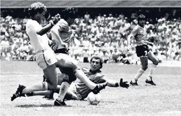  ??  ?? In this June 22, 1986 file photo, Argentina’s Diego Maradona (second left) is about to score his second goal against England, during their FIFA World Cup quarter-final match, in Mexico City, Mexico.