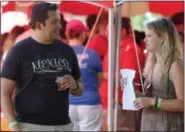  ?? JONATHAN TRESSLER — THE NEWS-HERALD ?? Parma Heights resident Alex Krupa, left, and Marlene Thompson from Akron compare notes on the different brews they sampled during the 2018 Chardon Brewfest even on the city’s square Aug. 11.