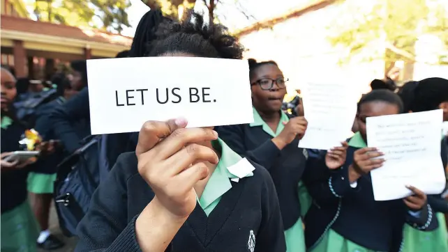  ?? Picture: PHILL MAGAKOE ?? HAIR-RAISING CONCERNS: Pupils at Pretoria High School for Girls picket inside the school premises while Gauteng MEC for Education Panyaza Lesufi met with the school management following allegation­s of racism.