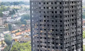  ?? Picture / AP ?? Firemen examine the scorched facade of the Grenfell Tower in London, the day after the massive fire.