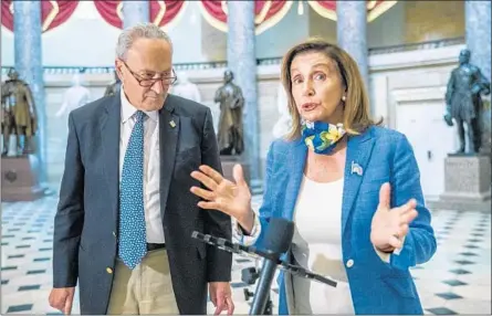  ?? MANUEL BALCE CENETA/AP ?? House Speaker Nancy Pelosi, with Senate Minority Leader Chuck Schumer, speaks to reporters Saturday in Washington.