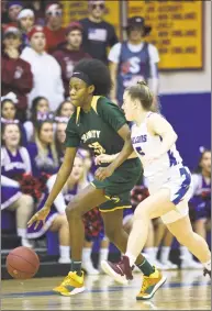  ?? H John Voorhees III / Hearst Connecticu­t Media ?? Trinity Catholic’s Iyanna Lops, left, is defended by St. Paul’s Emma Cretella in the CIAC Class S semifinals on March 8.