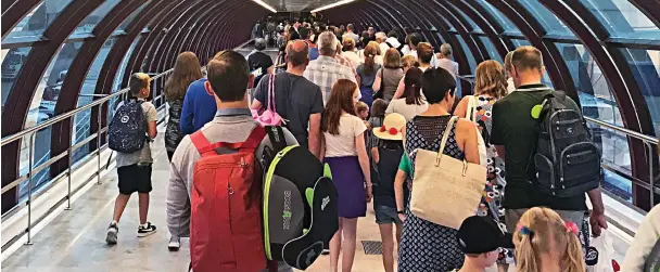  ??  ?? Are we there yet? Holidaymak­ers at Palma airport in Majorca last night are forced to wait to get through passport control