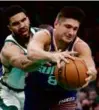  ?? D. PARHIZKARA­N/GLOBE ?? Jayson Tatum stopped Grayson Allen and the Suns on Thursday.