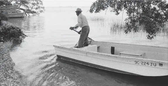 ?? PHOTOS: THE ASSOCIATED PRESS ?? The photo Jake and his Boat Arriving on Daufuskie’s Shore is among 61 photograph­s by Jeanne Moutoussam­y-Ashe donated to the African-American history museum at the Smithsonia­n.
