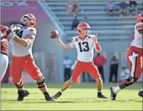  ?? Ap-michael Woods ?? Georgia quarterbac­k Stetson Bennett throws a pass against Arkansas during the first half of an NCAA football game in Fayettevil­le, Ark.