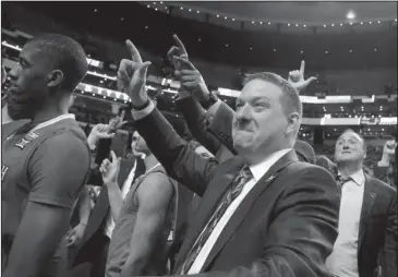  ?? The Associated Press ?? ANTAGONIST: Texas Tech coach Chris Beard celebrates with his team Friday after a 78-65 win in Boston over Purdue, eliminatin­g the Boilermake­rs from the NCAA Tournament for the second time in three years.